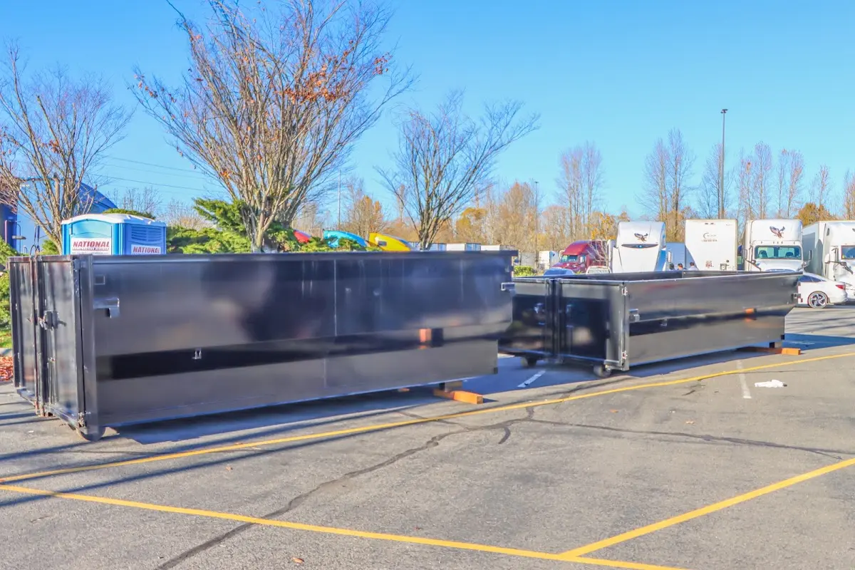 Professional dumpster rental service with roll-off container on residential driveway in Las Vegas